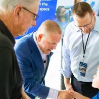Brian Kelly shaking hands with a child at the Jamie Hosford Football Center dedication.